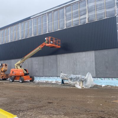 Metal panels starting to go up around the gym. The plastic above will eventually all be windows. 